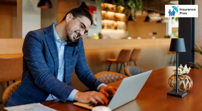 businessman-working-on-laptop-and-talking-on-phone-in-a-restaurant